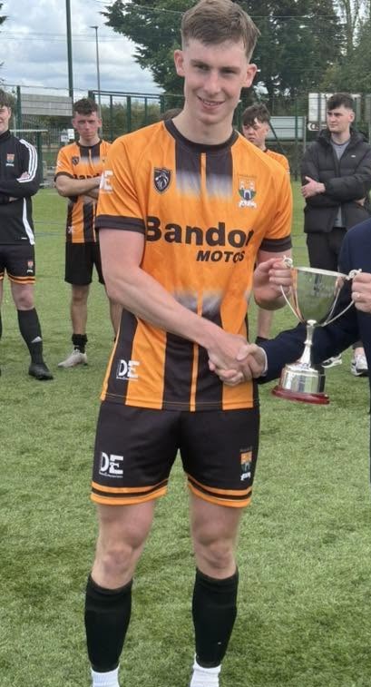 Innishvilla AFC player wearing the club's orange and black kit colours