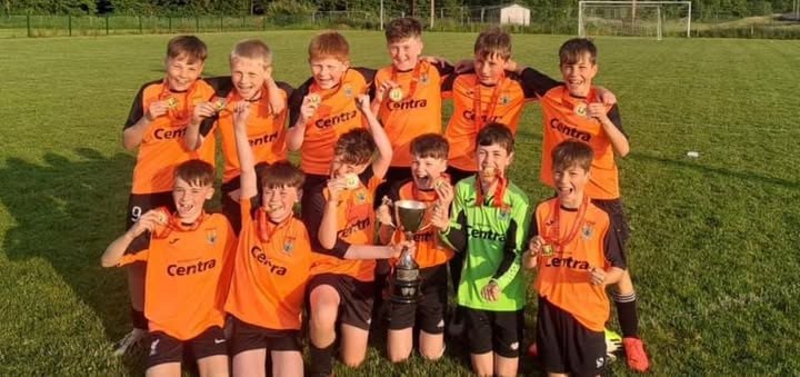Innishvilla AFC youth team celebrating together with a trophy
